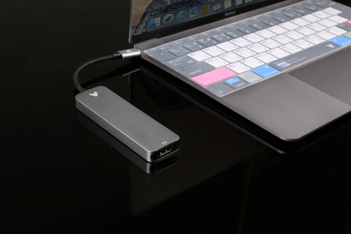 USB hub connected to a laptop on a tabletop.